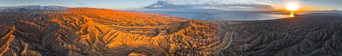 Panorama, river bed runs through a landscape of eroded hills at Lake Issyk Kul, badlands at
