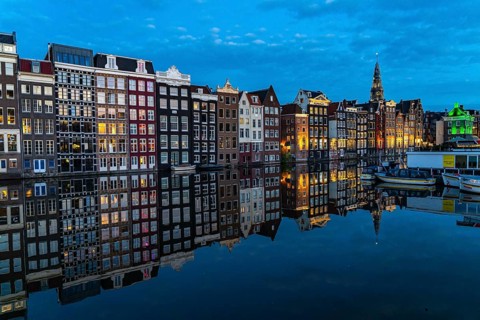 Canal houses on the Damrak, in the centre of the old town of Amsterdam, harbour, starting point of