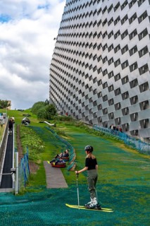 CopenHill, waste incineration plant and artificial ski slope, skiing with a view of the ski lift,