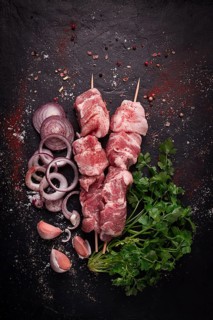 Raw pork meat, pickled kebab, with spices, top view, no people