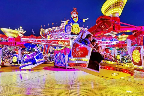 People in the illuminated carousel Circus Circus in the evening, Cranger Kirmes, Herne, Ruhr area,