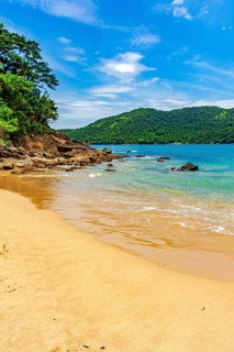 Remote and paradisiacal beach in Trindade, municipality of Paraty, surrounded by hills and tropical