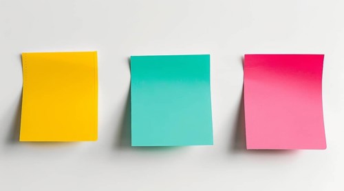 Three colourful post-it sticky notes are hanging on a white wall, AI generated