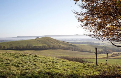 Picked Hill chalk outlier landscape misty valley floor, Vale of Pewsey, from Woodborough Hill,