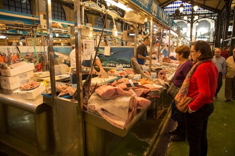 People shopping at fishmonger stalls inside historic covered market building, Jerez de la Frontera,