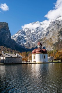 Königssee with Watzmann massif and pilgrimage church St. Bartholomä, autumnal mountain landscape,