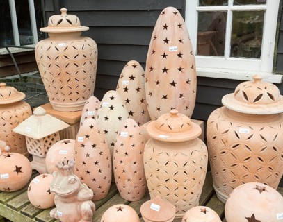 Display of clay lanterns on sale, The Walled garden plant nursery, Benhall, Suffolk, England, UK