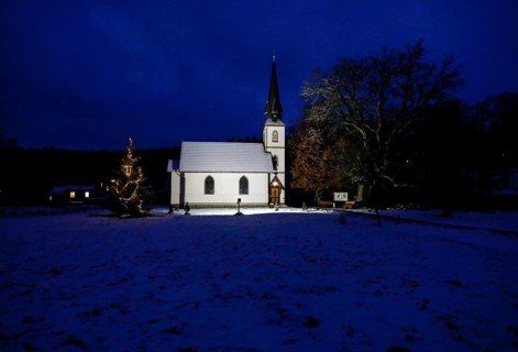 A Christmas tree stands in front of the smallest wooden church in Germany, Elend, 29 December 2020