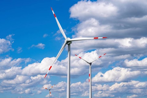 Wind turbine, wind energy plant from the manufacturer Enercon, blue sky with many white clouds,