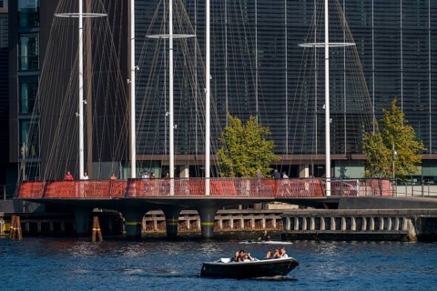 Cyclists on the Cirkelbroen cycle and pedestrian bridge, over the harbour, in the Christianshavens