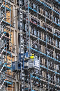 Construction site, construction site lift, new construction of a high-rise office building, facade