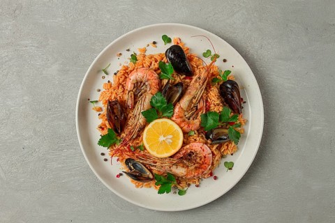 Seafood paella, shrimp and mussels risotto, rice, homemade, top view, no people