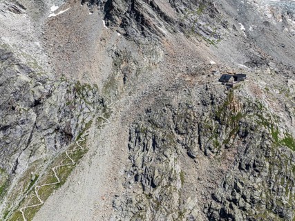 Mountain hut Cabane de Moiry, serpentines of hiking trail, aerial view, Valais, Switzerland, Europe