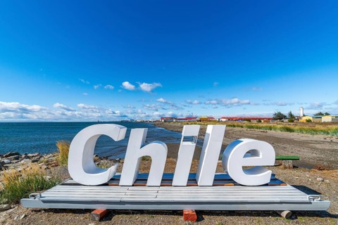 Huge letters form the word Chile on the beach of the Strait of Magellan, Nao Victoria Museum, city