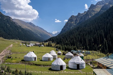 Yurts for tourists in the village of Altyn Arashan, green mountain valley, Tien Shan Mountains,
