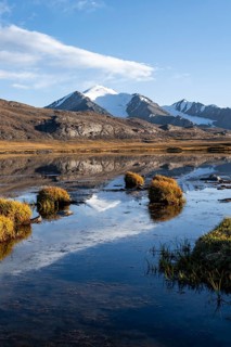 Glaciated mountain peaks reflected in a mountain lake at sunset, Arabel Lake at Arabel Pass, Issyk