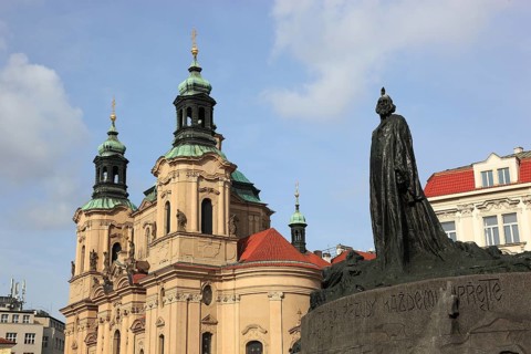 Jan Hus Monument on Old Town Square and the baroque St Nicholas Church, Prague, Czech Republic,