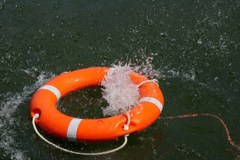 Red lifebuoy with lifeline in the water, distress at sea, drowning, accident, danger, shipping,
