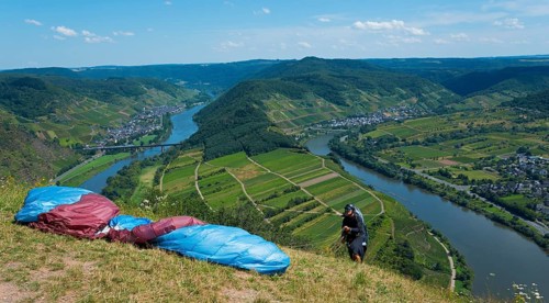 Paraglider ready, view over the river landscape and green hills, paragliding, Bremm, Cochem,