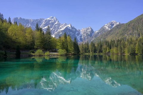 Mangart mountain range reflected in the lower Fusine Lake, Tarvisio, province of Udine, Italy,