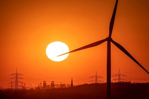 Wind turbine of the Emschergenossenschaft, view to the west, in Essen, sunset, behind the blast