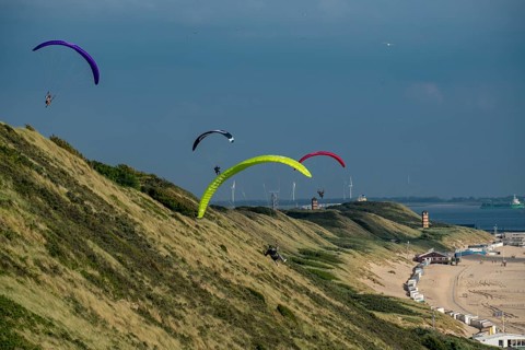 Paragliders along the dunes of Zoutelande, in Zeeland, South Holland, Netherlands