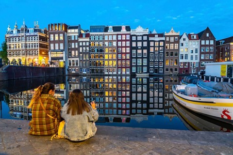 Canal houses on the Damrak, in the centre of the old town of Amsterdam, harbour, starting point of