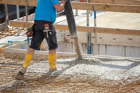 Construction site, concreting, the floor slab of a building is concreted, the concrete is pumped
