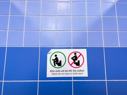 Sign in a public toilet, do not place on the toilet seat