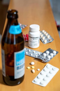 Symbolic image of alcohol and medication, you should not take medicine, pills, tablets with