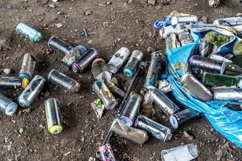 Paint cans, leftover rubbish from graffiti sprayers, under the motorway bridge, the A43 over the