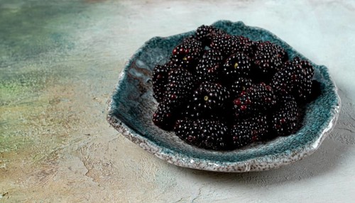 Fresh blackberry berry, on a plate, top view, no people