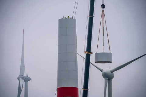 Construction of the tower of a wind power plant in a wind farm near Issum, 9 older wind turbines