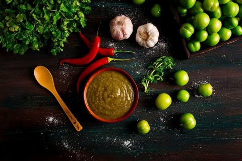 Tkemali sauce, traditional Georgian cuisine, green cherry plum, with ingredients for sauce,