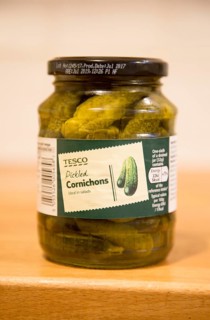 Glass jar of Tesco pickled Cornichons showing label, UK