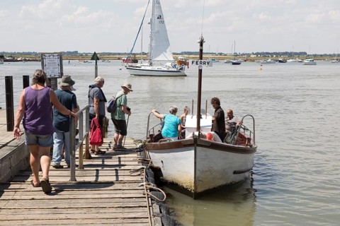 Passengers boarding River Deben foot passenger ferry boat at Bawdsey Quay, Suffolk, England, UK