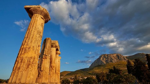 Archaic Temple of Apollo, Doric Columns, Doric columns of ancient ruins under a dramatic sunset