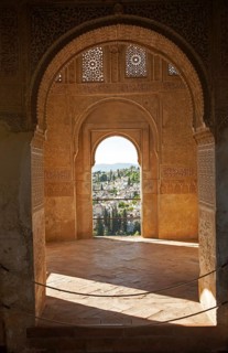 Stone arches in Islamic key shape in the Generalife palace, Alhambra, Granada, Spain, Europe