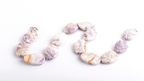 Agate colored beads isolated on white background. top view, close up