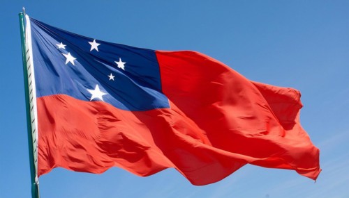 The flag of Samoa, fluttering in the wind, isolated against a blue sky