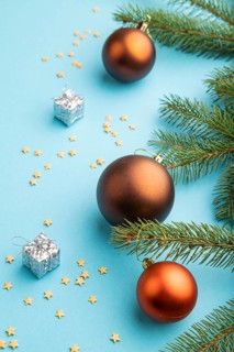 Christmas or New Year composition. Decorations, bronze balls, fir and spruce branches, on a blue