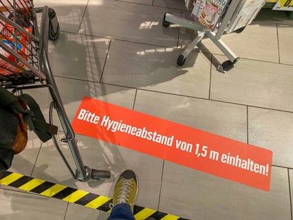 Effects of the corona crisis in Germany, sticker on the floor informs customers of a supermarket