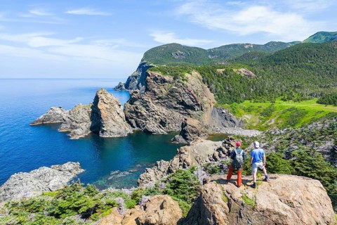 Aerial view, drone photo: Two men standing on a cliff above Bottle Cove, Bottle Cove Provincial