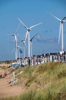 Wind turbines, wind farm, holiday homes, beach houses on the beach of Ijmuiden in North Holland,