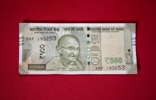 Indian 500 rupee currency bank note on a red background