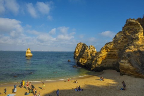 Rocky coast with beach and red rocks, Praia do Camilo, Lagos, Algarve, Portugal, Europe