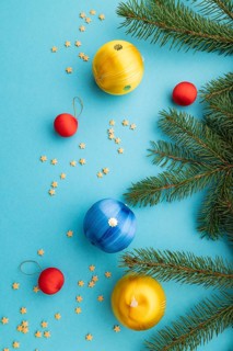 Christmas or New Year composition. Decorations, blue, red, yellow balls, fir and spruce branches,
