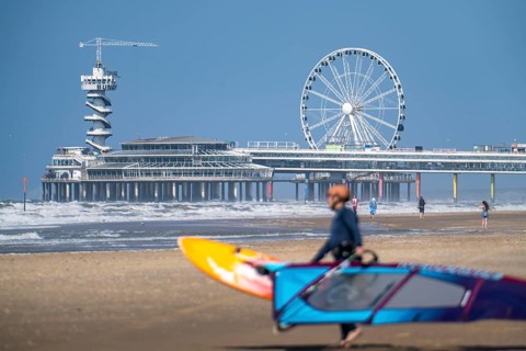 The pier and Ferris wheel at Scheveningen beach, strong swell, windsurfers, Netherlands