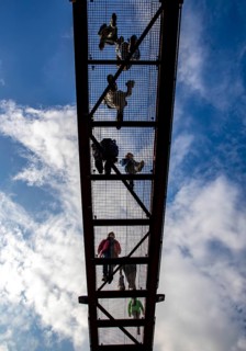 Lattice walkway, people walk over a walkway at a height of a good 15 metres, made of steel lattice,