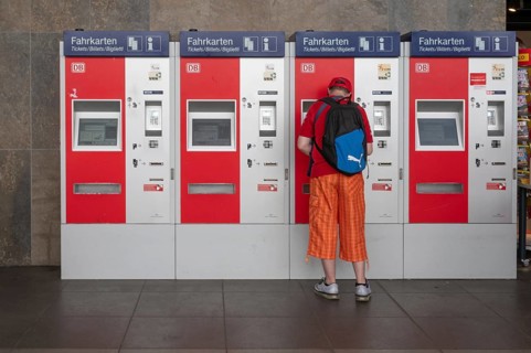 Railway customer buys a ticket at the ticket machine, Würzburg, Lower Franconia, Bavaria, Germany,